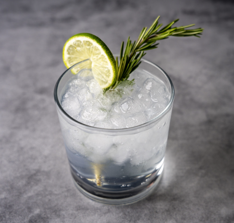 Gin and tonic with lime and rosemary garnish