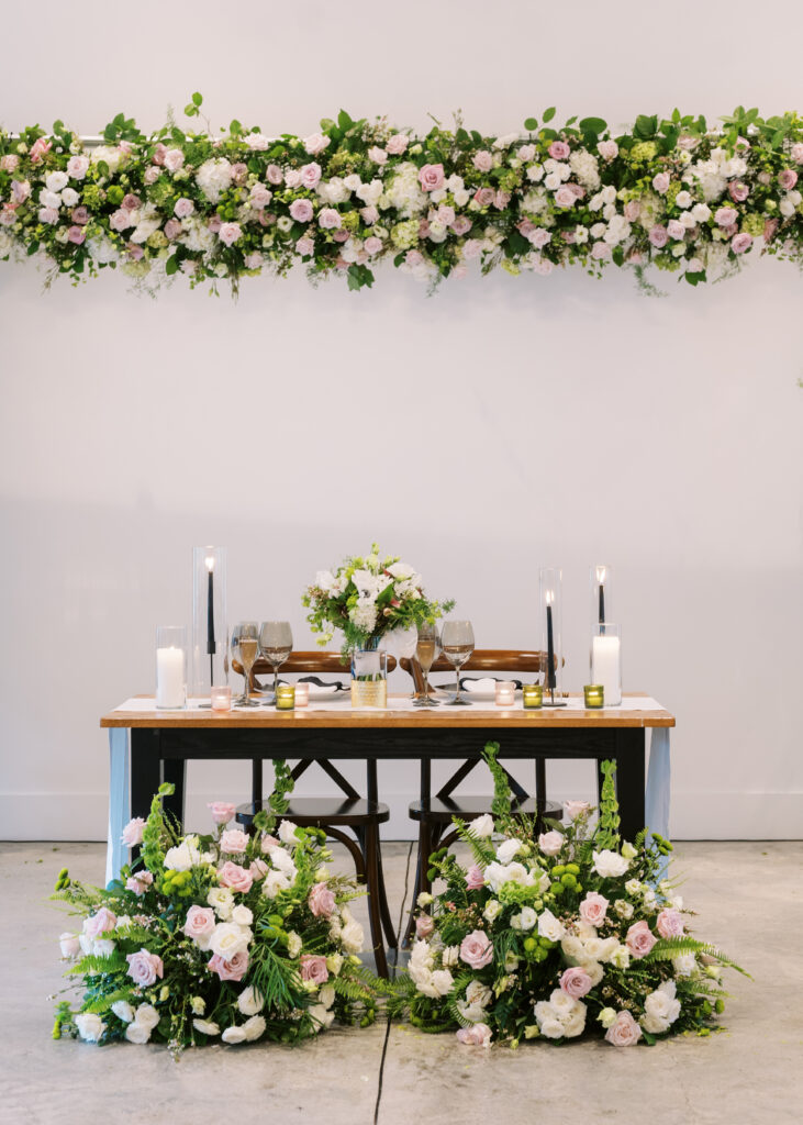 Farmhouse sweetheart table with candles and beautiful roses